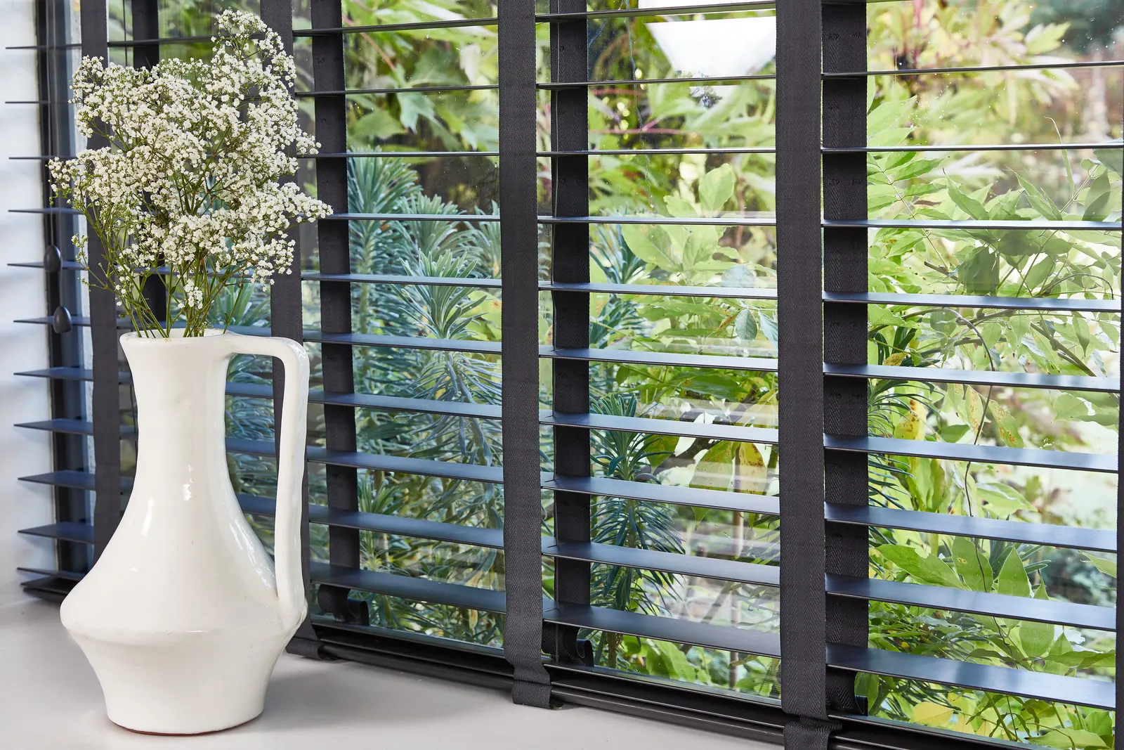 Faux wood slat blinds at a window – Northfield Blinds